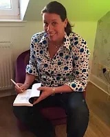 Lee Cockburn signing copies of her book