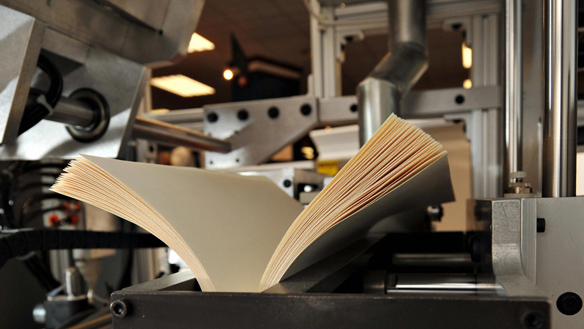 A book being bound on the printing press
